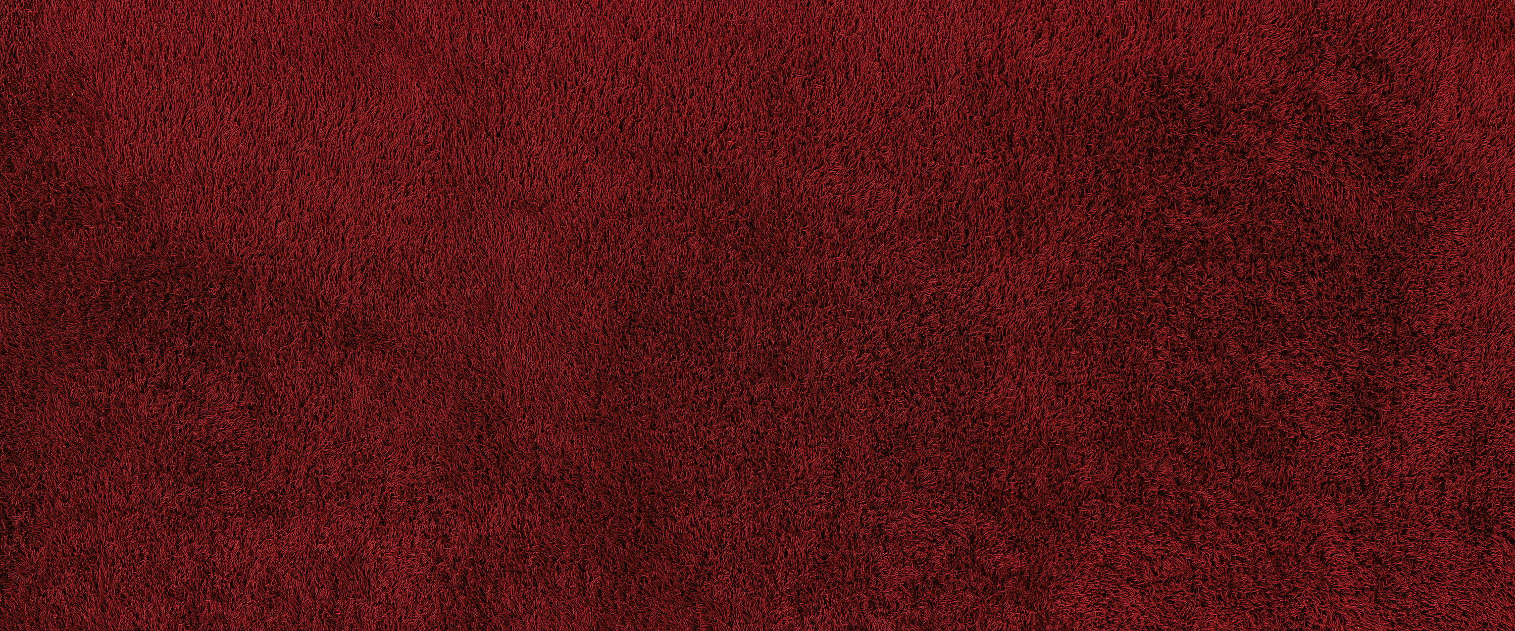             Fototapete Detailaufnahme eines roten Teppichs
        