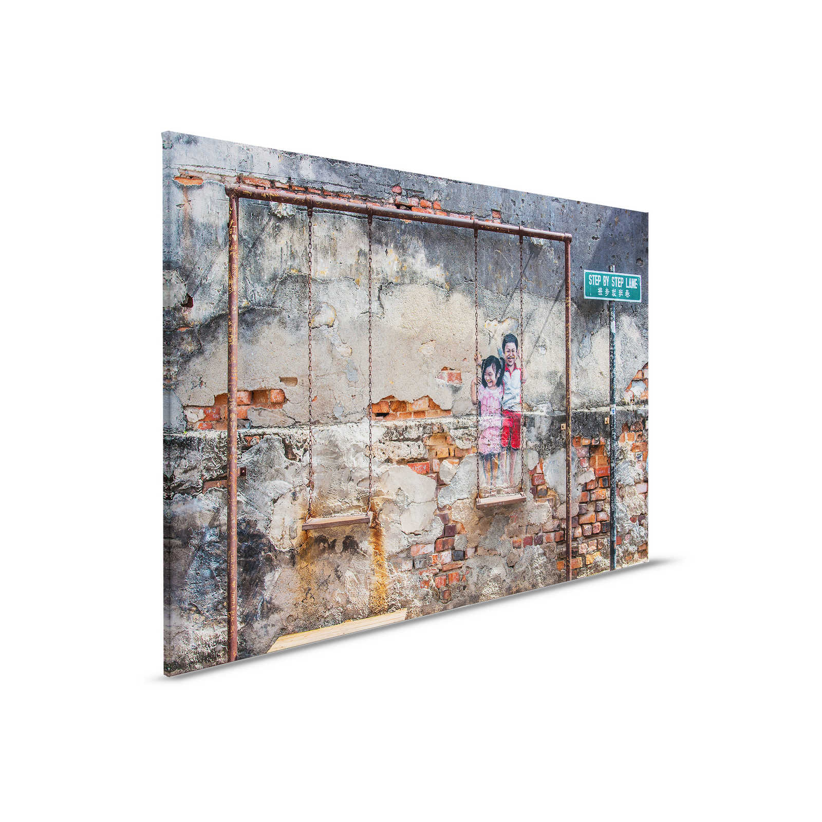 Leinwandbild Steinwand mit Wandbild und Schaukel – 0,90 m x 0,60 m
